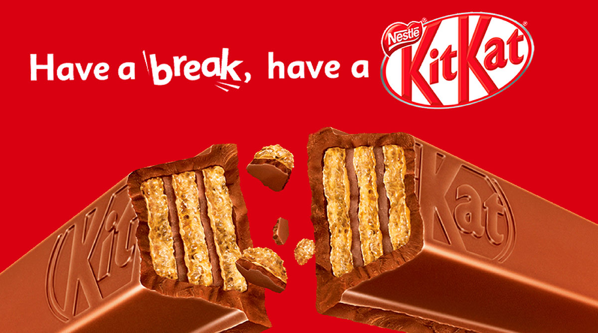 KitKat bar broken in half showing wafer layers under the slogan Have a break, have a KitKat on a red background
