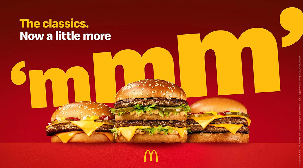 Three McDonald's burgers including a Big Mac under large yellow mmm text and the headline The classics. Now a little more