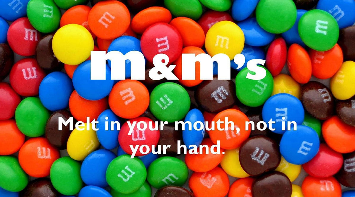 Colorful M&M's candies filling the frame with the M&M's logo and the slogan Melt in your mouth, not in your hand